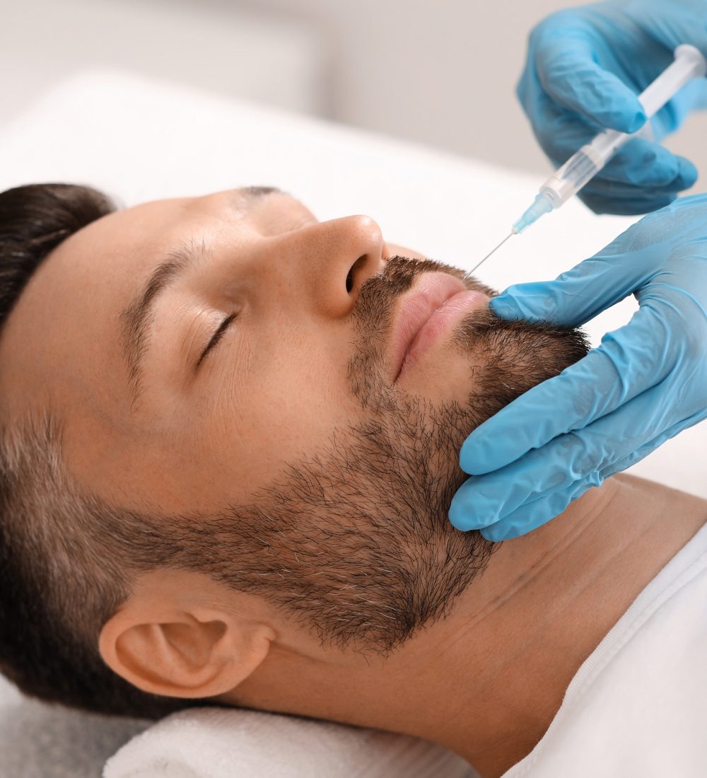 Attractive man visiting aesthetic clinic, getting lips filler Attractive man visiting aesthetic clinic, getting lips filler